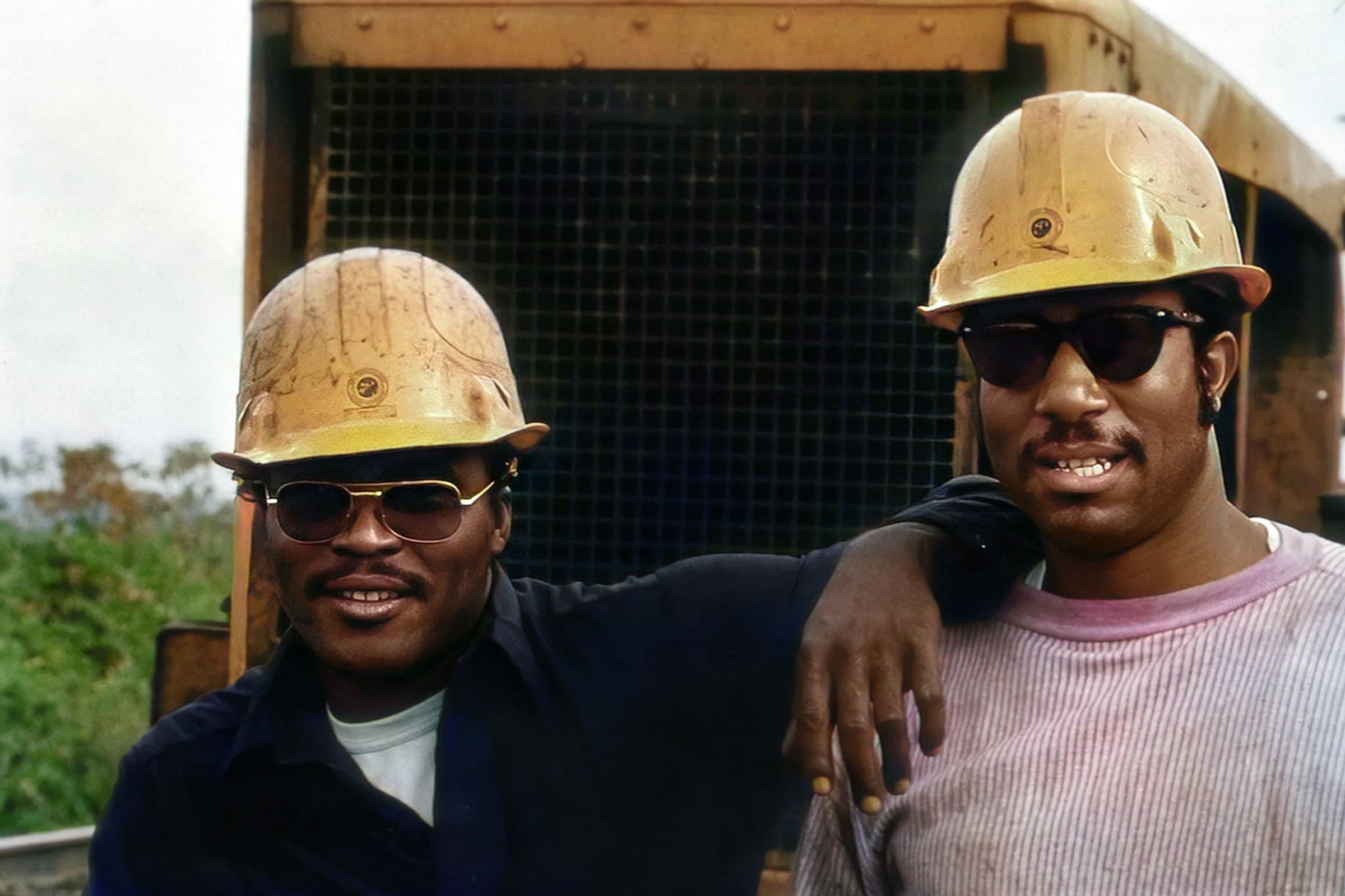 Two friendly tradespeople smiling on the job site